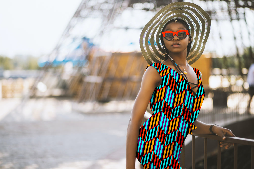Woman wearing a colorful patterned dress and straw hat with sunglasses, standing outdoors.

Vibrant Aqua Blue and Orange Chevron seamless pattern. High-resolution geometric print for textile and apparel design.