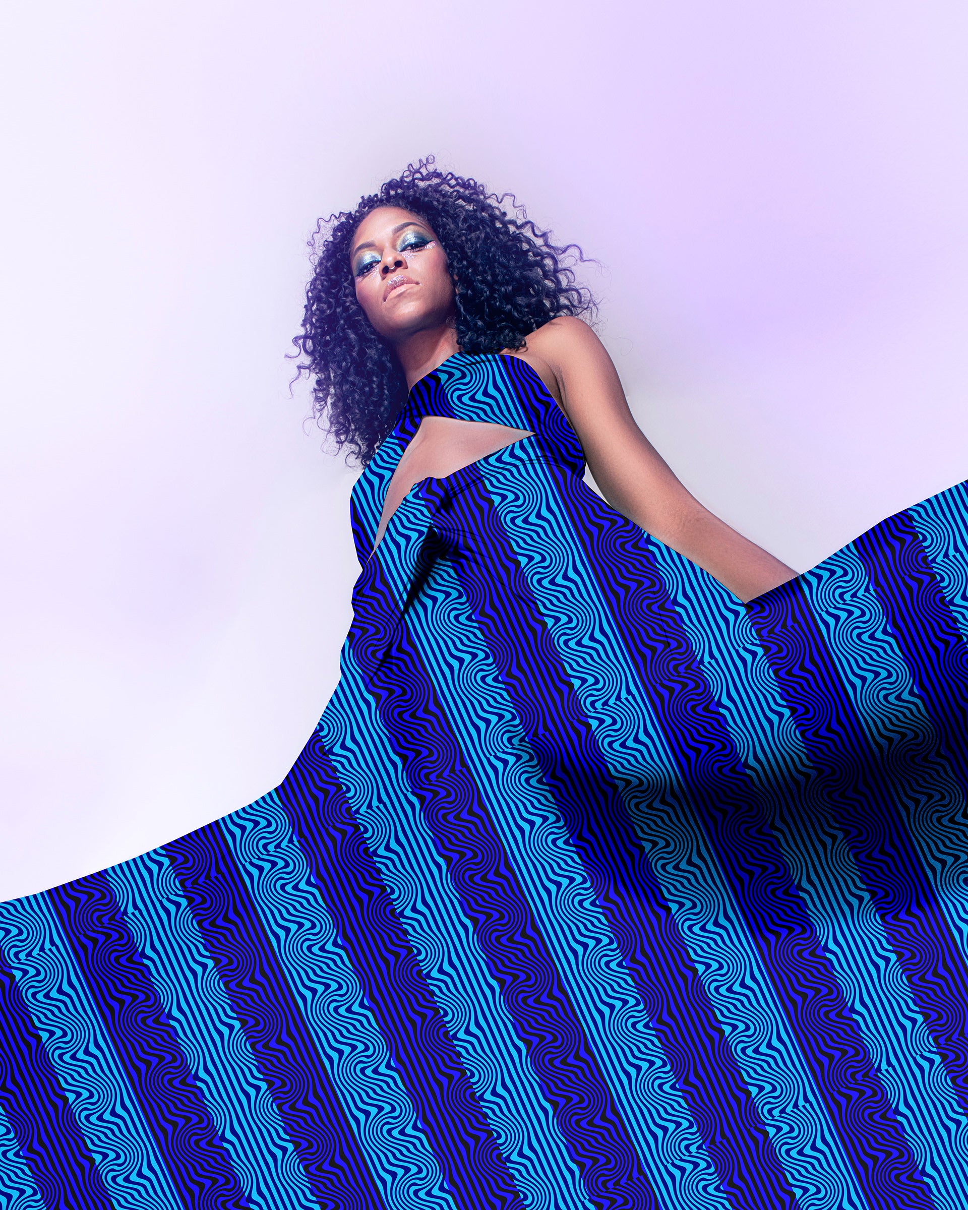 Woman wearing a blue patterned dress against a white background

Blue Wavy Textured Stripe seamless pattern (10 Colour Ways). High-resolution fluid geometric print for fabric and apparel design.