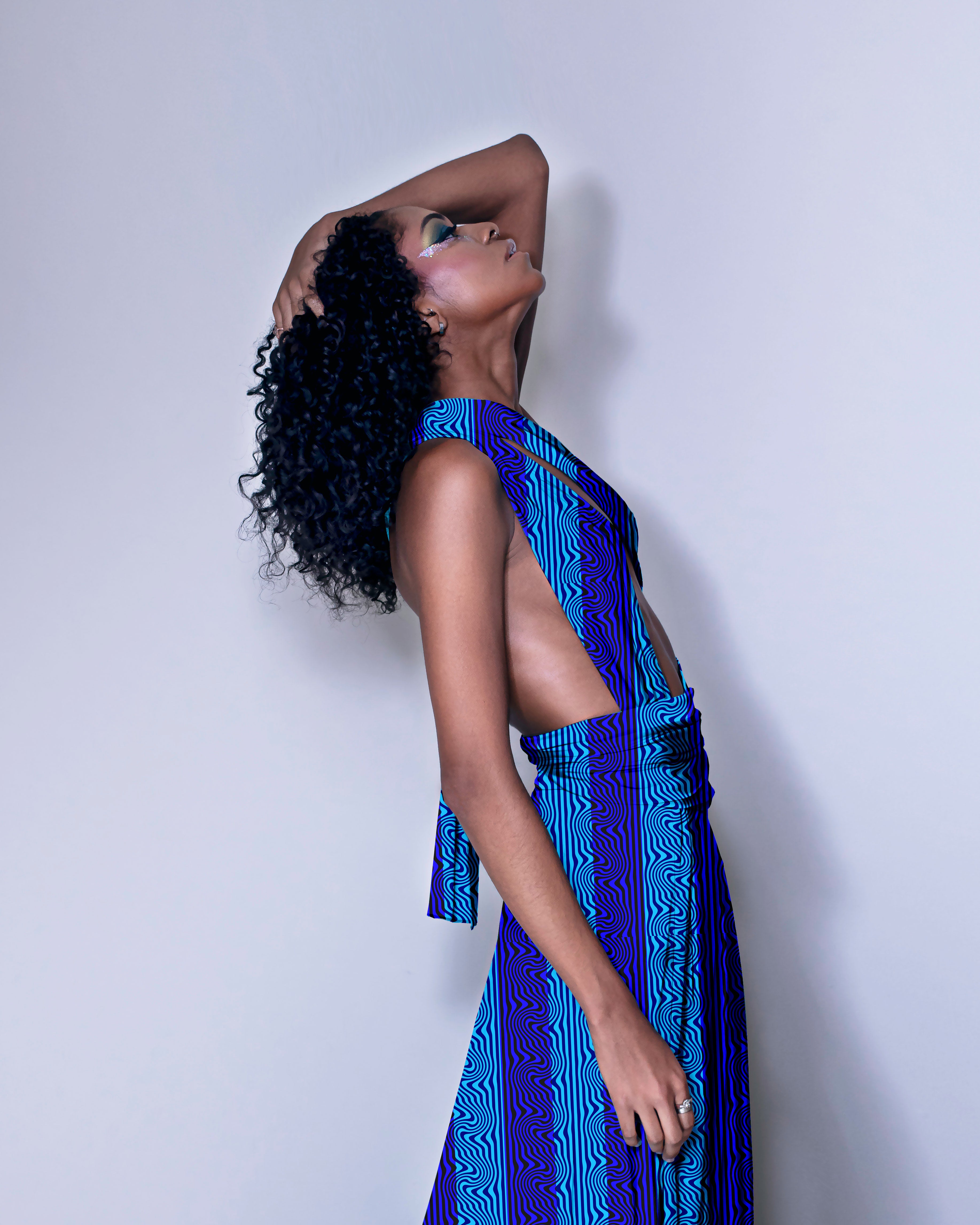 Woman wearing a blue patterned dress against a white background

Blue Wavy Textured Stripe seamless pattern (10 Colour Ways). High-resolution fluid geometric print for fabric and apparel design.