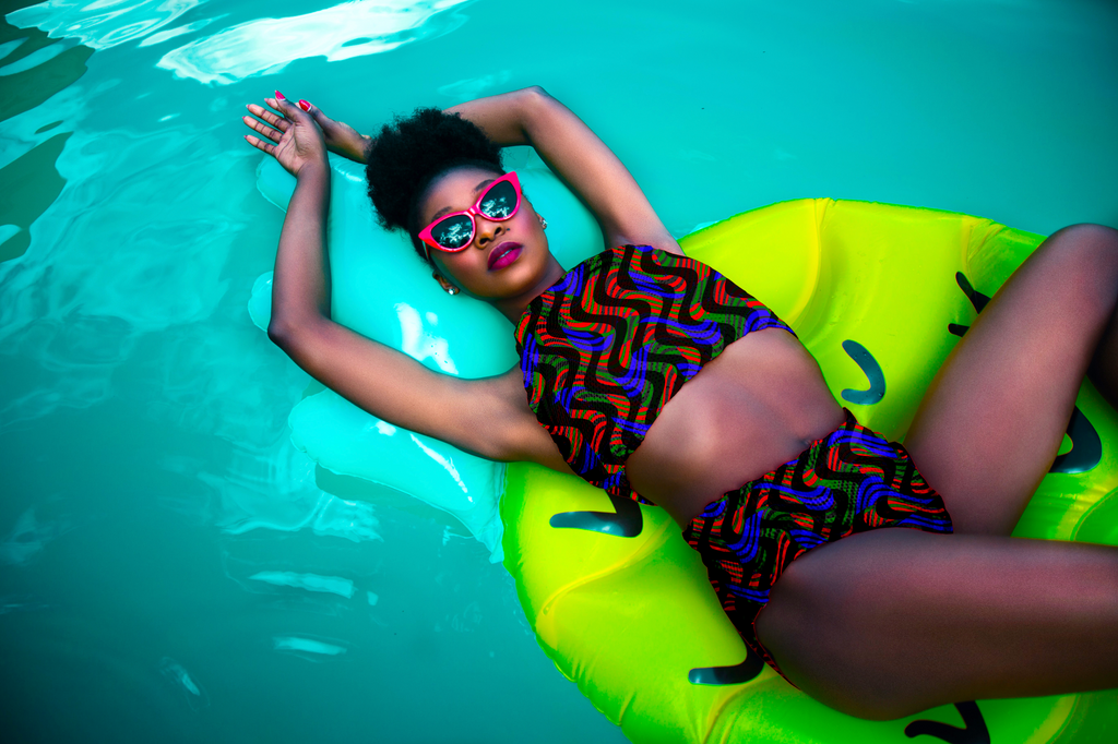 Person lounging on a green inflatable ring in a pool, wearing a colorful swimsuit and sunglasses.

Vibrant Blue and Red Wavy Stripe Chevron seamless pattern. High-resolution dynamic geometric print for textile and apparel design.