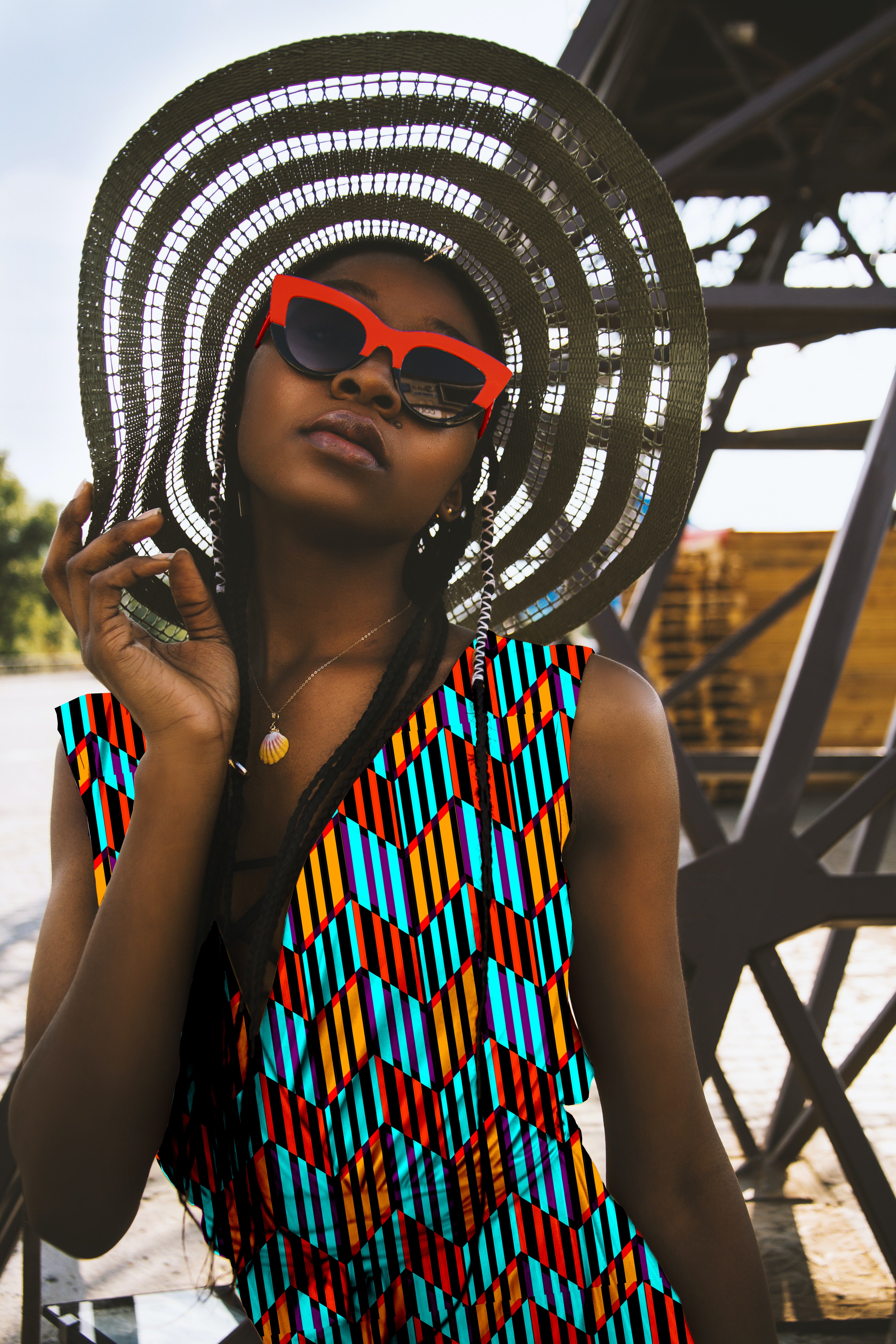 Woman wearing a colorful patterned dress and large hat with sunglasses, standing against an industrial background.

Vibrant Aqua Blue and Orange Chevron seamless pattern. High-resolution geometric print for textile and apparel design.